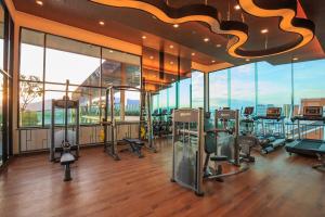 a gym with a bunch of exercise equipment in a building at The Astra Condo, Downtown in Chiang Mai