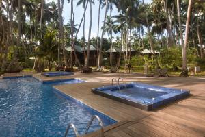 a resort with three swimming pools and palm trees at Sea Shell Resort & Spa, Havelock in Havelock Island