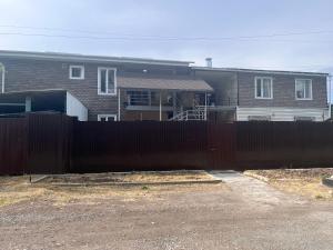 a black fence in front of a house at Sayakatchy hostel in Bishkek
