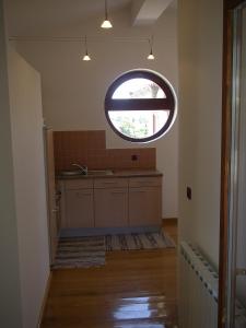 a kitchen with a large round window in the ceiling at Apartments Premantura in Premantura +56 photos