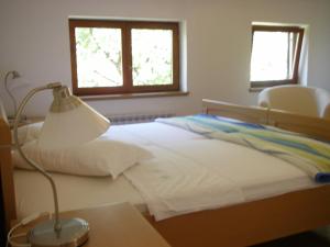 a bedroom with a bed with a lamp and a window at Apartments Premantura in Premantura