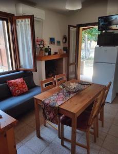 a living room with a table and a couch at Bouganville in Costa Rei +13 photos