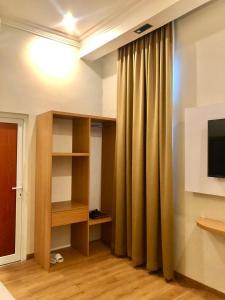TV a/nebo společenská místnost v ubytování Garuda Hotel By Calandra