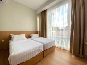 Postel nebo postele na pokoji v ubytování Garuda Hotel By Calandra + 15 fotografií
