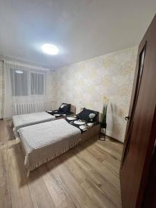 a bedroom with two beds in a room at MB BENO TRUMPALAIKE NUOMA LUKSIUKAs in Kėdainiai