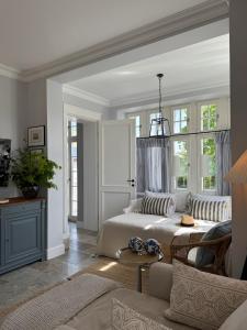 a bedroom with two beds and a couch at SeeBlick Apt 7 Bałtyk Luxury Residence in Międzyzdroje