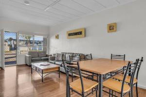 a living room with a table and a couch at Seasider in Merimbula