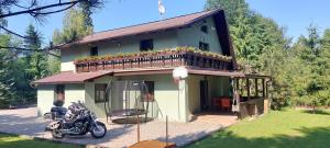 a motorcycle parked in front of a house at Chata Bella in Smižany