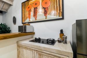 a kitchen with a stove and a microwave at Villa Cemacase in Cemagi +38 photos