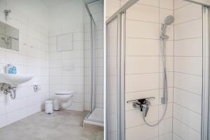 a bathroom with a shower and a toilet at Apartmenthaus Eldena in Greifswald +21 photos