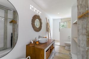 a bathroom with a sink and a mirror on the wall at Villa Cemacase - Stylish 2BR Villa with Spacious Private Pool & Pool Table in Seseh in Cemagi