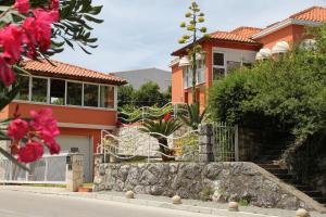 a house with a stone wall in front of a house at Seaside family friendly house with a swimming pool Mlini, Dubrovnik - 2145 in Mlini
