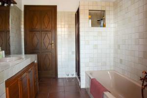 a bathroom with a tub and a sink at B&B il Baciass in Pinerolo