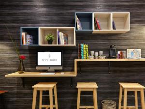 an office with a desk with a computer and two stools at Pensión Peñaflorida in Donostia-San Sebastián