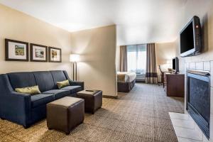 a living room with a couch and a tv at Comfort Suites at Par 4 Resort in Waupaca