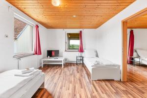 a living room with two beds and a tv at GÜNSTIGE Wohnungen für Monteure in Suppingen-Laichingen TV,Wifi,Parking in Laichingen