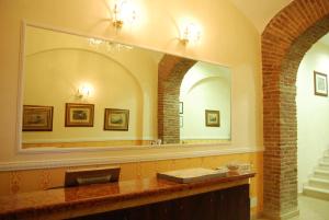 a bathroom with a sink and a large mirror at Hotel Hollywood in Rome