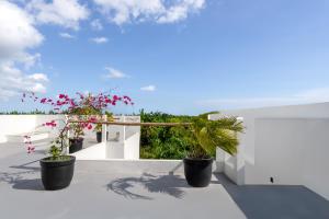 a view from the balcony of a house with potted plants at Enaya Villa by Betterplace in Tumbak Bayuh