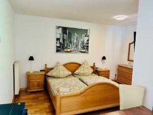 a bedroom with a bed and a picture on the wall at Landhaus Magnus in Ramberg