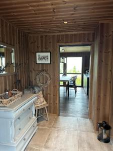 Habitación con paredes de madera y pasillo con mesa. en High standard Cabin close to Norefjell, 