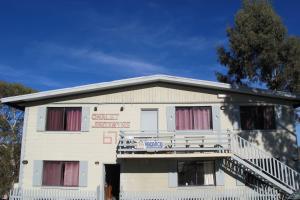 a white building with windows and a balcony at Chalet Jindabyne in Jindabyne