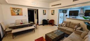 a living room with a couch and a table at JLT 1BR Marina Skyline View in Dubai