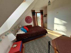 a bedroom with a bed in a attic at Bursztynowa 1 in Sztutowo