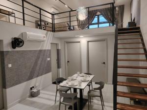 a room with a table and chairs and a staircase at 1-12PAXKuala Lumpur Near Taman MIDAH Cheras 2 Car Parking normally 1 parking only in Kuala Lumpur
