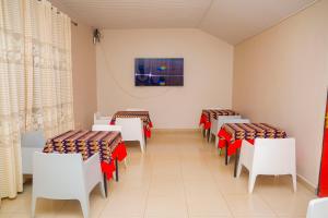 a row of tables and chairs in a room at Baobab Hotel LTD in Kigali