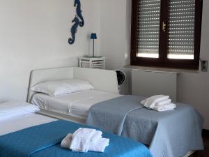 a bedroom with two beds with towels on them at Relax in Riva in Monopoli