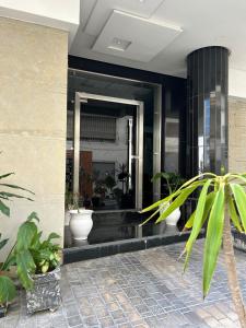 a lobby of a building with potted plants at Sofia 1 Tanger #Castilla in Tangier