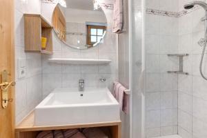 a white bathroom with a sink and a shower at Ausser Brugghof in Senales