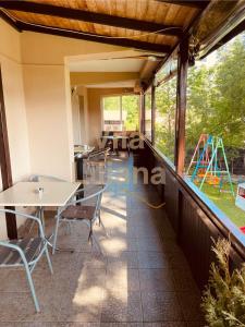 a balcony with tables and chairs and a playground at Vila Liliana in Predeal