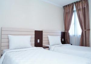 Postel nebo postele na pokoji v ubytování Travellers Suites Serviced Apartments