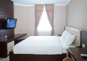 Postel nebo postele na pokoji v ubytování Travellers Suites Serviced Apartments + 33 fotografií