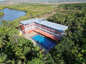 an aerial view of a resort with a swimming pool at Savali Resort in Diveagar