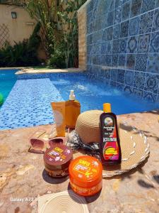 a group of products sitting next to a swimming pool at Orient Villa-Dead Sea in Sowayma +28 photos