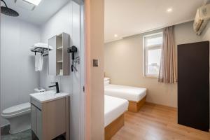 a small bathroom with a sink and a toilet at Beijing Liangcang Hotel 10-minute walk to Tiananmen Square and the Forbidden City Free registration service for Tiananmen access 200 meters from the subway Beijing Cultural Hub Free coffee & free laundry service in Beijing +60 photos