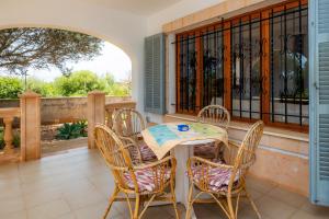 a patio with a table and chairs on a balcony at Sa Torre Nova Ref 50 in Sant Llorenç des Cardassar