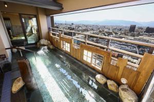 a view from the top of a building with a swimming pool at Onyado Nono Matsumoto Natural Hot Spring in Matsumoto