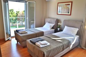 two beds in a room with a window at Eglina Celeste Villa in Minia +39 photos