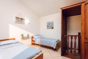 Ένα ή περισσότερα κρεβάτια σε δωμάτιο στο VILLETTA ESCLUSIVA CON GIARDINO, San Teodoro Paradiso Terrestre