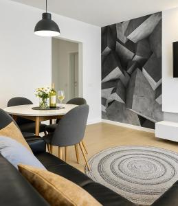 a living room with a table and a stone wall at M&S Lux Apartments - cisza, balkon, 5 min od Manufaktury in Łódź