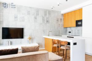 a kitchen with a bar and a tv on a wall at Boulevard 129 in Tashkent