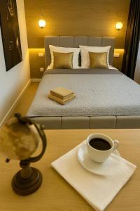 a bed with a cup of coffee on a table at M&S Lux Apartments - cisza, balkon, 5 min od Manufaktury in Łódź
