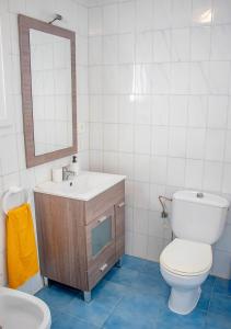 a bathroom with a toilet and a sink and a mirror at MojacarProperty, Casa Ginés 1ª Línea de Playa in Mojácar +24 photos