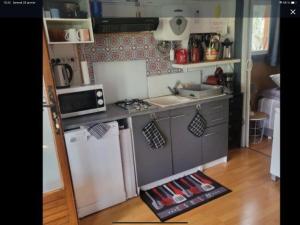 a small kitchen with a stove and a refrigerator at chalet Bati in Bonifacio