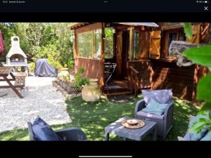 a yard with chairs and a table and a house at chalet Bati in Bonifacio