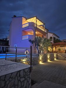a large house with lights on the side of it at Villa M in Crikvenica