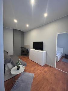 a living room with a couch and a tv at KunK in Ventspils +5 photos